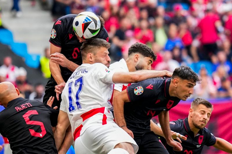 Albania's Berat Djimsiti, top, goes for a header with Croatia's Bruno Petkovic during a Group B match between Croatia and Albania at the Euro 2024 soccer tournament in Hamburg, Germany, Wednesday, June 19, 2024. (AP Photo/Ebrahim Noroozi)