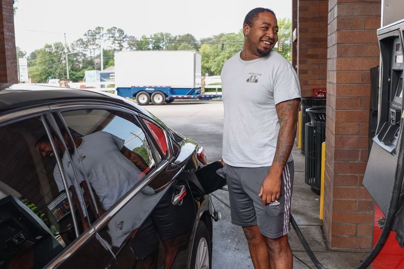 Immanuel Williams pumps gas in Roswell on Tuesday. The Biden administration is taking steps aimed at bringing down gas prices.