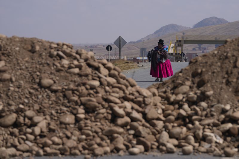 Rocks block a highway towards Lake Titicaca in Vilaque on the outskirts of El Alto, Bolivia, Monday, Sept. 16, 2024. The roadblock was placed by protesters demanding the resignation of Bolivian President Luis Arce for his management of the economy. (AP Photo/Juan Karita)