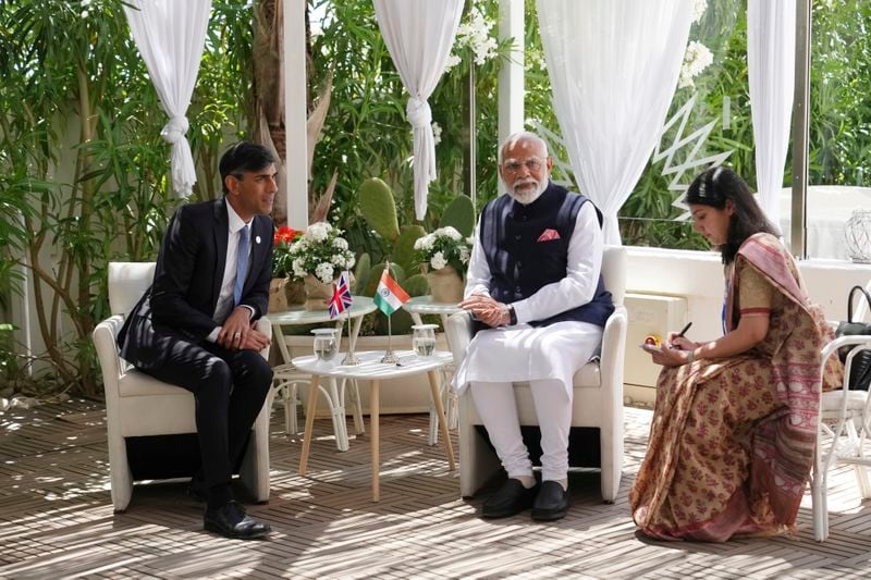 British Prime Minister Rishi Sunak, left, attends a meeting with Prime Minister of India Narendra Modi, center, on the sidelines of day two of the 50th G7 summit, in Borgo Egnazia, southern Italy, Friday, June 14, 2024. (Christopher Furlong/Pool Photo via AP)