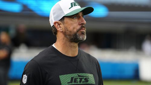 New York Jets quarterback Aaron Rodgers walks on the field before a preseason NFL football game against the Carolina Panthers, Saturday, Aug. 17, 2024, in Charlotte, N.C. (AP Photo/Jacob Kupferman)