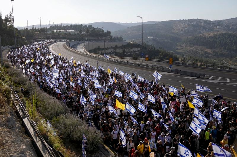 Family members and supporters of the hostages held captive by Hamas in Gaza complete the final leg of a four-day march from Tel Aviv to Jerusalem to demand the immediate release of all hostages in Jerusalem on Saturday, July 13, 2024. (AP Photo/Mahmoud Illean)