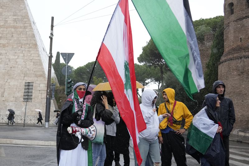 People stand during a protest in Rome, Saturday, Oct. 5, 2024. Pro-palestinians people take to the street in an unauthorised march in the centre of Rome two days ahead of the first anniversary of the Oct. 7. (AP Photo/Andrew Medichini)