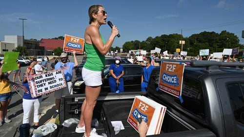 August 1, 2020 Marietta - Amy Henry leads parents, students and community members during a rally to call on Superintendent Chris Ragsdale and the Cobb school board to offer in-person classes alongside virtual learning outside Cobb County Civic Center in Marietta on Saturday, August 1, 2020. The protesters gathered Saturday at the Cobb County Civic Center to call on Superintendent Chris Ragsdale and the Cobb school board to offer in-person classes alongside virtual learning to students returning to the classroom Aug. 17. (Hyosub Shin / Hyosub.Shin@ajc.com)