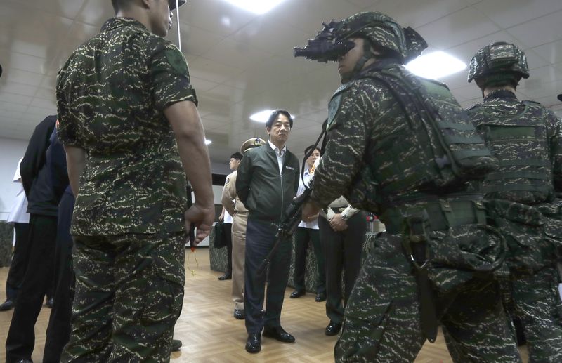 Taiwan President Lai Ching-te, center, listens to the briefing during his visit to inspect Taiwanese military in Taoyuan, Northern Taiwan, Thursday, May 23, 2024. (AP Photo/Chiang Ying-ying)