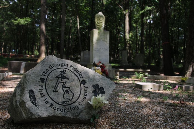 Fiddlin' John Carson's grave and family plot lie in East Atlanta's Sylvester Cemetery. Carson's 1923 recording of “Little Log Cabin in the Lane” and “The Old Hen Cackled" became the first hit record in the genre now known as country music, according to music historian Robert Oermann. (Jeremy Turley / Jeremy.Turley@ajc.com)