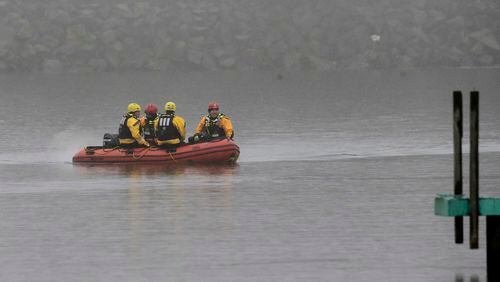 A boat carrying a recovery team rides on the shoreline of Lake Erie, Tuesday, Jan. 3, 2017, in Cleveland. Cleveland officials say the search for a plane carrying six people that disappeared last week over Lake Erie has resumed. Tuesday marks the third straight day that conditions have allowed recovery teams to search the lake for a Columbus-bound Cessna 525 Citation that vanished from radar shortly after takeoff Thursday night from Burke Lakefront Airport. (AP Photo/Tony Dejak)