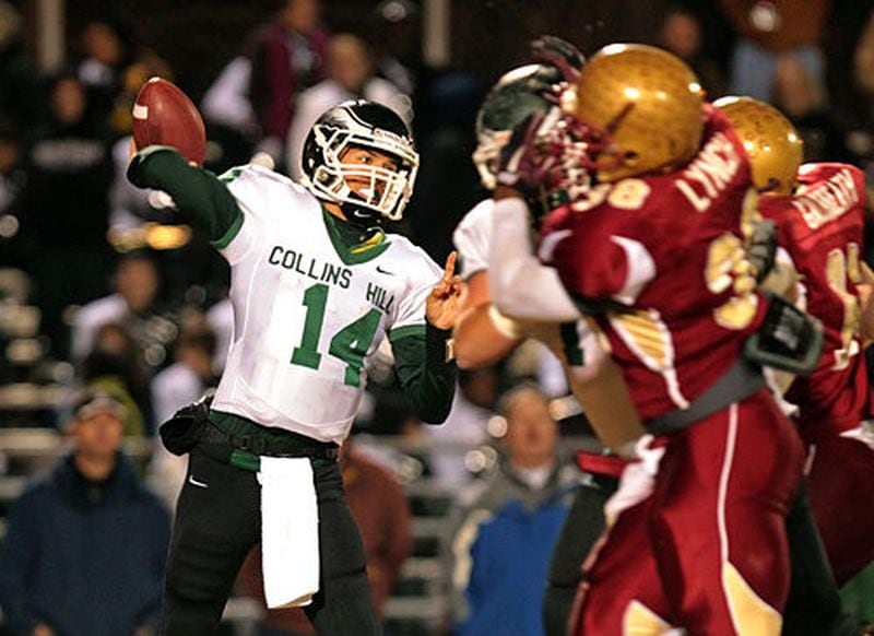 Collins Hill quarterback Taylor Heinicke (14) attempts a pass under a rush by Brookwood during the first half. Heinicke threw a touchdown pass for a 7-3 Eagles score at the half.