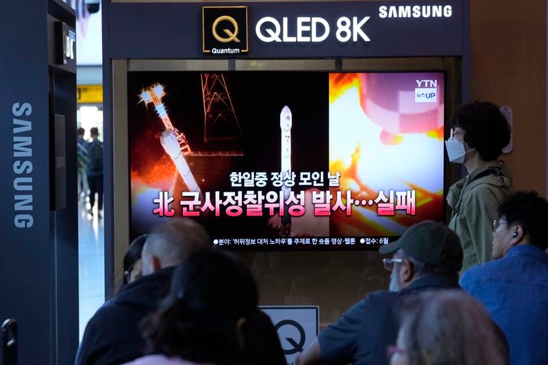 A news program broadcasts file images of a rocket launch by North Korea, at the Seoul Railway Station in Seoul, South Korea, Tuesday, May 28, 2024. A rocket launched by North Korea to deploy the country's second spy satellite exploded shortly after liftoff Monday, state media reported, in a setback for leader Kim Jong Un's hopes to field satellites to monitor the U.S. and South Korea. The writing on the screen reads "A North Korea spy satellite launch failed on a day when the leaders of South Korea, Japan and China gather." (AP Photo/Ahn Young-joon)