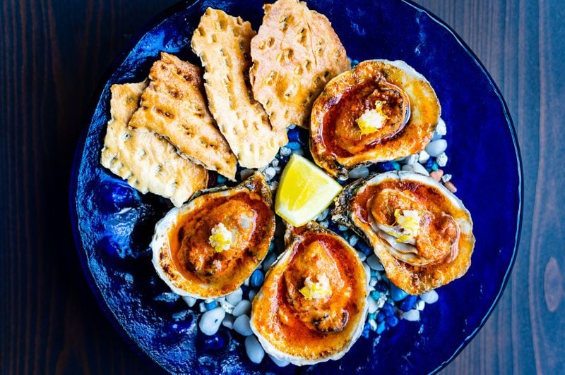 Roasted oysters with Calabrian chiles and saltines at Cold Beer. CONTRIBUTED BY HENRI HOLLIS