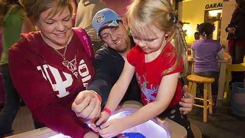 At the Children's Museum of Pittsburgh, parents and children explore the various stations of "XOXO: An Exhibit About Love & Forgiveness."