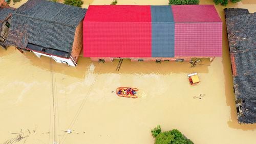 FILE - Rescuers use a dinghy boat to evacuate villagers trapped by floodwaters in Jingtang village, Zixing city, in southern China's Hunan province, on July 28, 2024. (Chinatopix via AP, File)