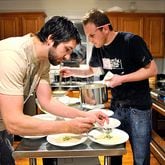 Ryan Hidinger (left) and his sous-chef Ben Barth serve fennel soup with apple relish at the Jan. 31 seating of Prelude to Staplehouse, an underground supper club.