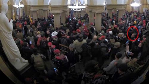 This image from security video of Michael Daniele, a retired New Jersey State Police trooper, seen in the Crypt in the U.S. Capitol on Jan. 6, 2021, was contained in the Justice Department affidavit and complaint in support of the arrest of Daniele. (Department of Justice via AP)