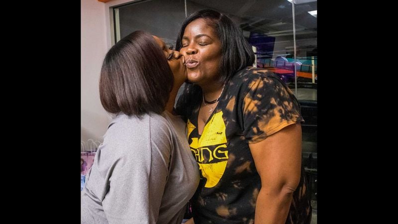 Kendrix Ladson kisses her daughter, Alyeese Williams, on the cheek. They graduated together at the end of the Spring 2023 semester at Georgia Piedmont Technical College. (Courtesy photo)

