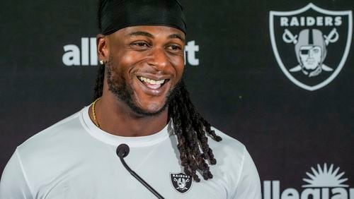 FILE - Las Vegas Raiders wide receiver Davante Adams (17) takes questions from the media after a NFL football training camp at Jack R. Hammett Sports Complex in Costa Mesa, Calif., July 24, 2024. (AP Photo/Damian Dovarganes, File)