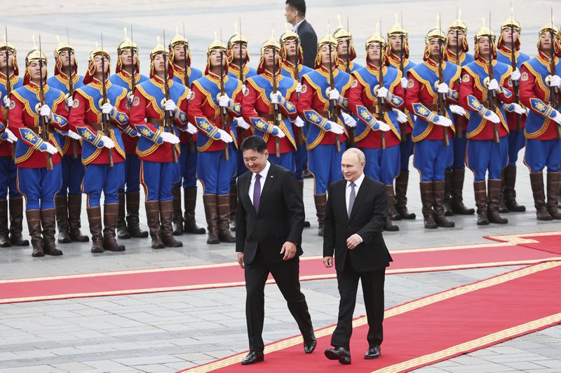 Russian President Vladimir Putin, right, walks with Mongolian President Ukhnaagiin Khurelsukh, left, during welcoming ceremony at Sukhbaatar Square in Ulaanbaatar, Mongolia, Tuesday, Sept. 3, 2024. (Sofya Sandurskaya, Sputnik, Kremlin Pool Photo via AP)