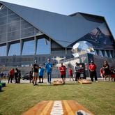 Panthers fan Benjamin Willis and Falcons fan Steven Lance (center) are seen playing corn hole by the Home Depot Backyard before the Falcons season opener against the Carolina Panthers on Sunday, Sept. 10, 2023, in Atlanta.
Miguel Martinz/miguel.martinezjimenez@ajc.com