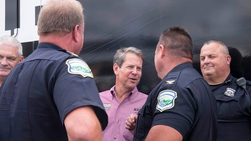 Gov. Brian Kemp, center, said Thursday that he is committing another $100 million in federal COVID-19 relief money for grants to law enforcement agencies to address violent crime and offset staffing shortages. (ALYSSA POINTER/ALYSSA.POINTER@AJC.COM)