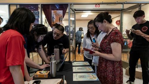 Members of the Las Vegas Asian community receive information on how to vote in Chinese during the annual Dragon Boat Festival in Las Vegas, Wednesday, June 5, 2024. Advocates are working to help non-English speakers access voting materials in their primary language. (Christopher Lomahquahu/News21 via AP)