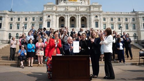 Gov. Tim Walz is seen at a ceremonial budget bill-signing party on the Minnesota State Capitol steps. (GLEN STUBBE/STAR TRIBUNE/GETTY IMAGES)