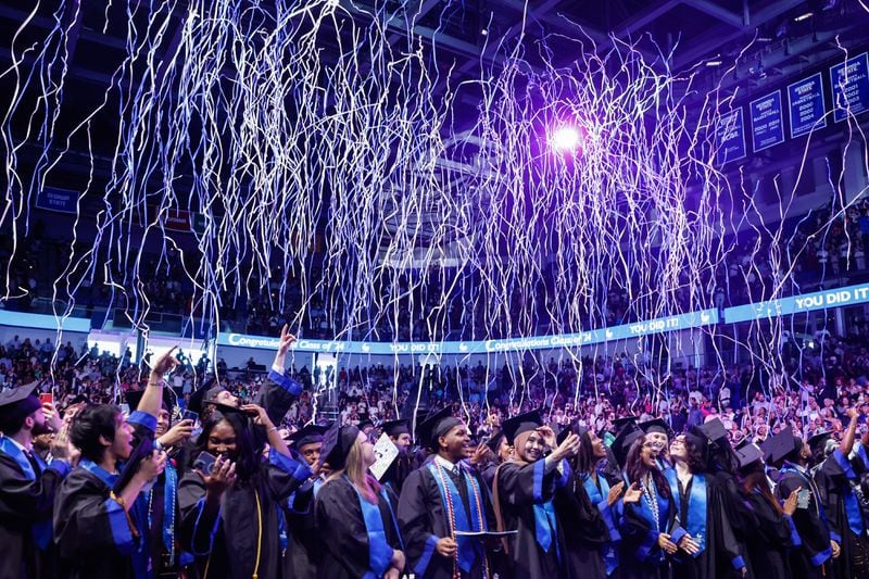 Streamers fall from the ceiling at the conclusion of the Georgia State University J. Mack Robinson College of Business morning graduation ceremony at the Georgia State Convocation Center in Atlanta on Thursday, May 2, 2024. (Natrice Miller/ AJC)