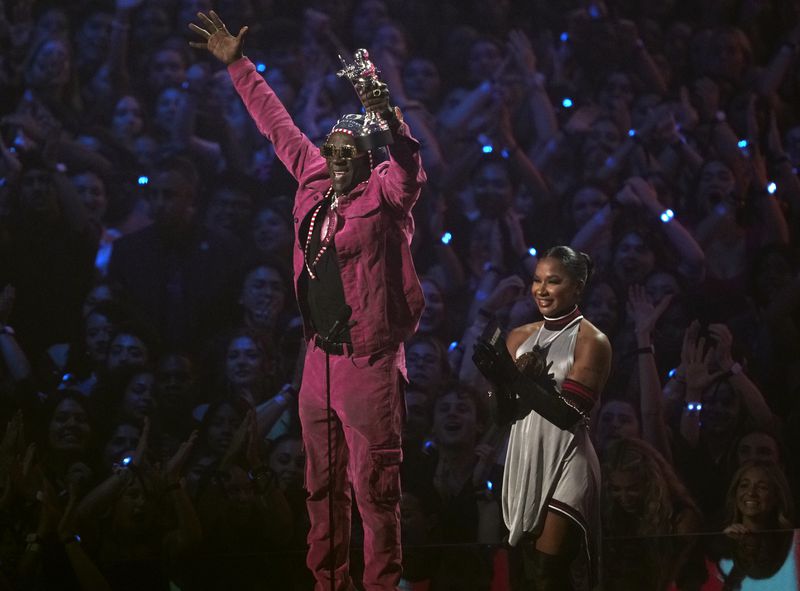 Flavor Flav, left, and Jordan Chiles present the award for best collaboration during the MTV Video Music Awards on Wednesday, Sept. 11, 2024, at UBS Arena in Elmont, N.Y. (Photo by Charles Sykes/Invision/AP)