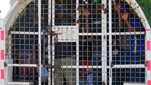 FILE - Undocumented Haitians detained by immigration officials stand inside a police vehicle, in Dajabon, Dominican Republic, May 17, 2024. (AP Photo/Matias Delacroix, File)