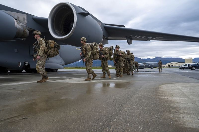 In this image released by the U.S. Air Force, U.S. Army Soldiers assigned to 1st Battalion, 501st Parachute Infantry Regiment, 2nd Infantry Brigade Combat Team (Airborne), 11th Airborne Division, board a U.S. Air Force C-17 Globemaster III assigned to the 176th Wing, Alaska Air National Guard, as part of a force projection exercise to Shemya Island, Alaska, at Joint Base Elmendorf-Richardson, Alaska, Sept. 13, 2024. (Airman 1st Class Hunter Hites/U.S Air Force via AP)