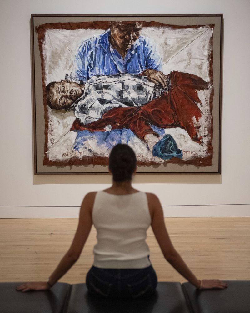 A woman looks at an artwork by Claudette Johnson during the Turner Prize 2024 press preview at Tate Britain in London, part of the 40th anniversary exhibition featuring four shortlisted artists, Tuesday, Sept. 24, 2024. (AP Photo/Thomas Krych)