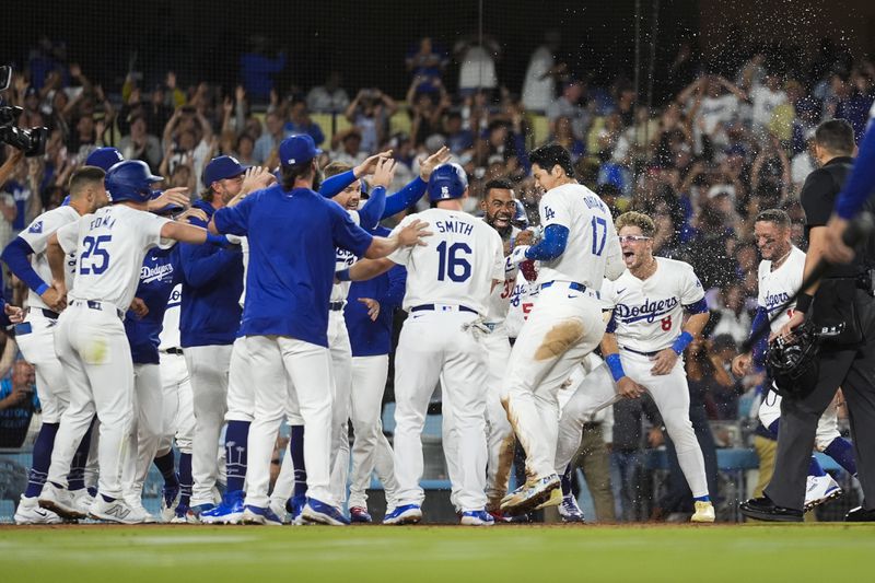 Los Angeles Dodgers designated hitter Shohei Ohtani (17) celebrates with teammates after hitting a grand slam during the ninth inning of a baseball game against the Tampa Bay Rays in Los Angeles, Friday, Aug. 23, 2024. The Dodgers won 7-3. (AP Photo/Ashley Landis)