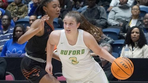 Buford's Tate Walters (3) drives around Kell's Amaya Moss during the Class AAAAA girls title basketball game Friday, March 6, 2020, at the Macon Centreplex in Macon.