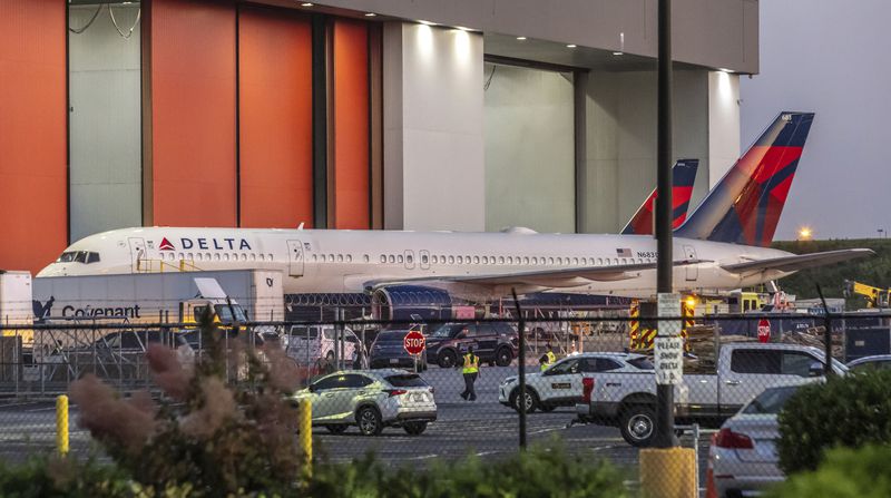 Multiple Atlanta Fire Rescue Department units and police park outside a Delta Maintenance facility near Hartsfield-Jackson International Airport early Tuesday, Aug. 27, 2024 in Atlanta. (John Spink/Atlanta Journal-Constitution via AP)