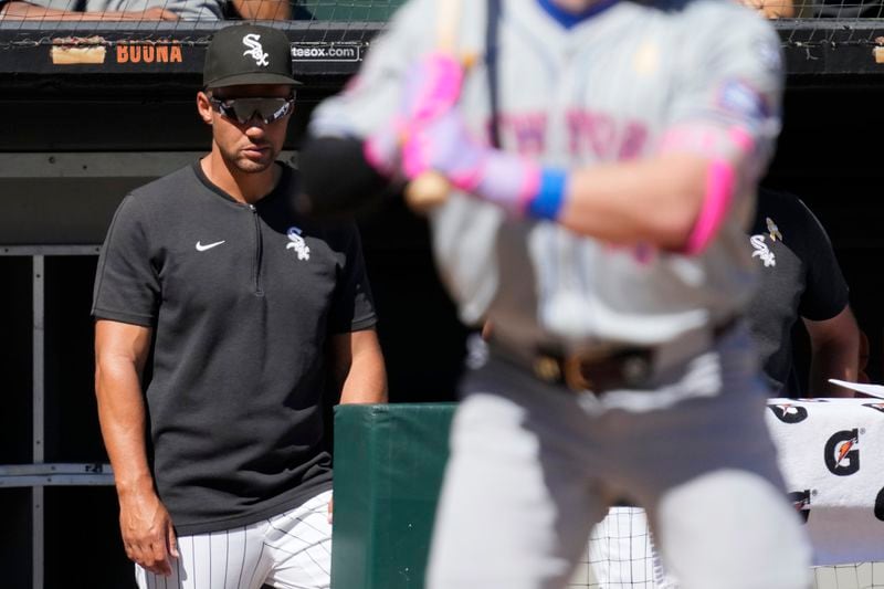 Chicago White Sox interim manager Grady Sizemore, left, watches New York Mets' Harrison Bader during the seventh inning of a baseball game in Chicago, Sunday, Sept. 1, 2024. (AP Photo/Nam Y. Huh)