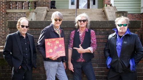 A 2023 photo of Athens-formed band Kilkenny Cats holding a copy of their "Hands Down" album on Barber Street in Athens. Left to right: Sean O'Brien, Tom Cheek, Allen Wagner and Keith Landers. Courtesy of Karen Allison / Propeller Sound Recordings.