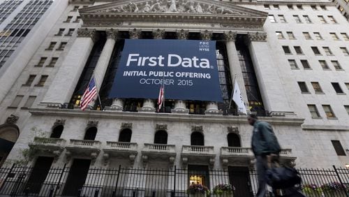A banner for First Data Corp. adorns the facade of the New York Stock Exchange, to mark the company’s IPO, Thursday, Oct. 15, 2015. First Data is the leading payment services provider to the e-commerce industry, and will pay a $40 million fine after being caught up in a fraud investiation by the Federal Trade Commission. (AP Photo/Richard Drew)