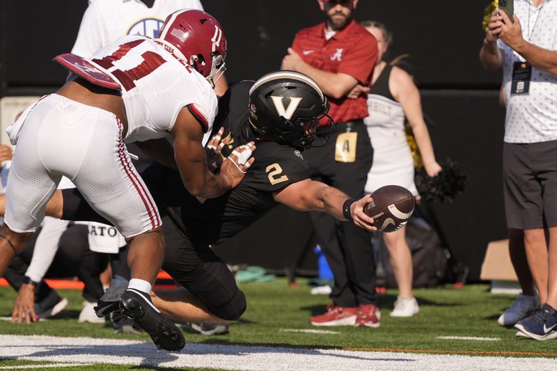 Vanderbilt quarterback Diego Pavia (2) dives for extra yards past Alabama linebacker Jihaad Campbell (11) during the first half of an NCAA college football game Saturday, Oct. 5, 2024, in Nashville, Tenn. (AP Photo/George Walker IV)