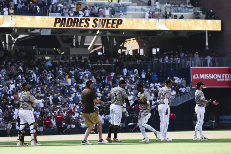 San Diego Padres' Jurickson Profar, third from right, celebrates with Robert Suarez after the team defeated the Chicago White Sox in a baseball game Sunday, Sept. 22, 2024, in San Diego. (AP Photo/Derrick Tuskan)