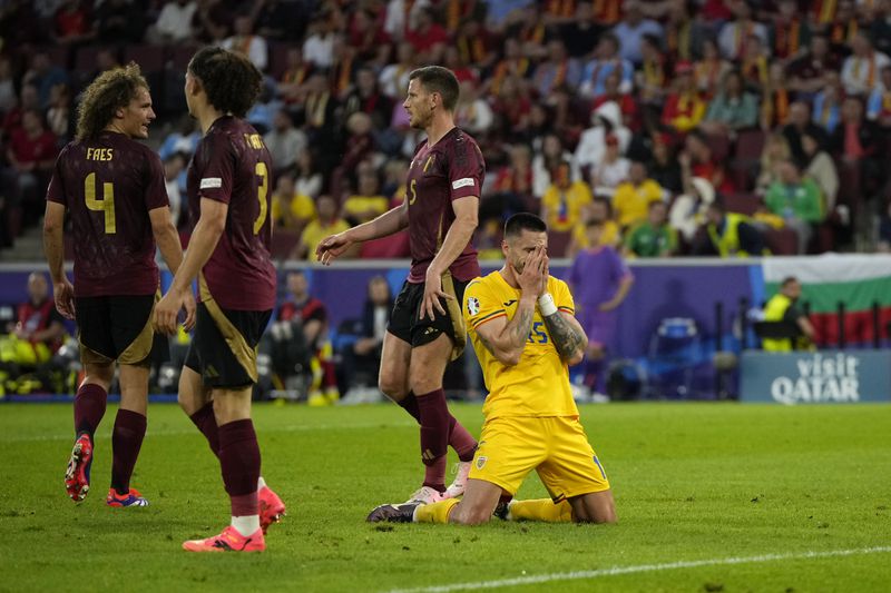 Romania's Andrei Burca reacts after missing a scoring chance during a Group E match between Belgium and Romania at the Euro 2024 soccer tournament in Cologne, Germany, Saturday, June 22, 2024. (AP Photo/Alessandra Tarantino)