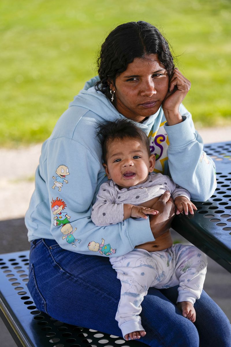 Ivanni Herrera holds her baby Milan Guzman during an interview in a park Friday, May 18, 2024, in Aurora, Colo. (AP Photo/Jack Dempsey)