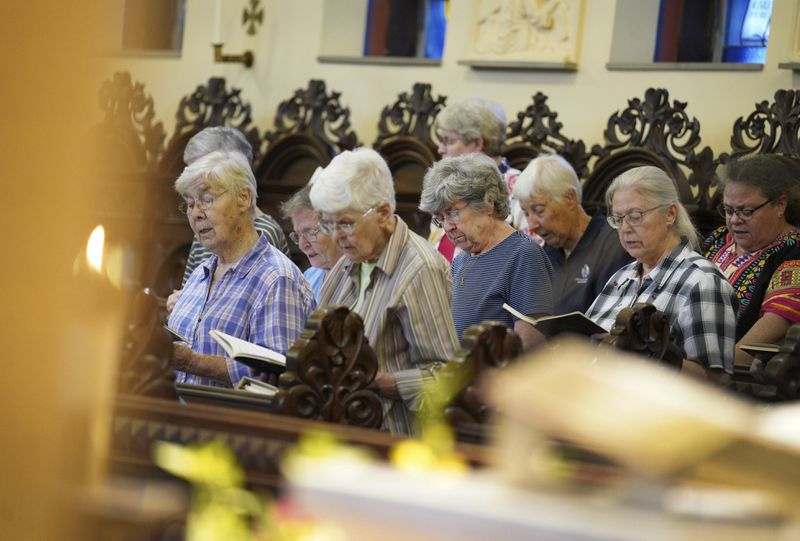 Sisters join in song during evening prayer at the Mount St. Scholastica Benedictine monastery in Atchison, Kan., Tuesday, July 16, 2024. (AP Photo/Jessie Wardarski)