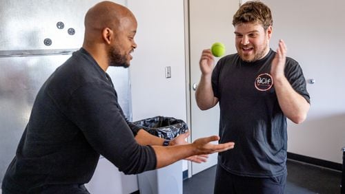 Coach Akeem McKie (left) works with Reece Blankenship during his FITLIGHT® session at the ReClif fitness-based therapy center in Peachtree Corners Tuesday, Feb. 14, 2023.  (Steve Schaefer/steve.schaefer@ajc.com)