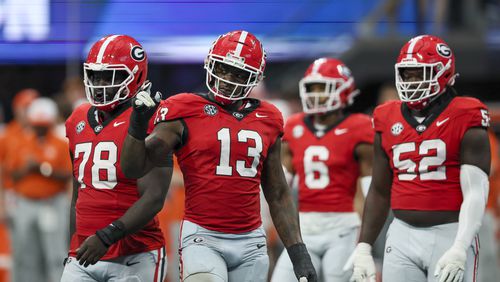 Georgia defensive linemen Nazir Stackhouse (78), Mykel Williams (13) and Christen Miller (52) prepare for a defensive play during their game against Clemson at Mercedes-Benz Stadium, on Saturday, Aug. 31, 2024, in Atlanta. Georgia won 34-3. (Jason Getz/AJC)