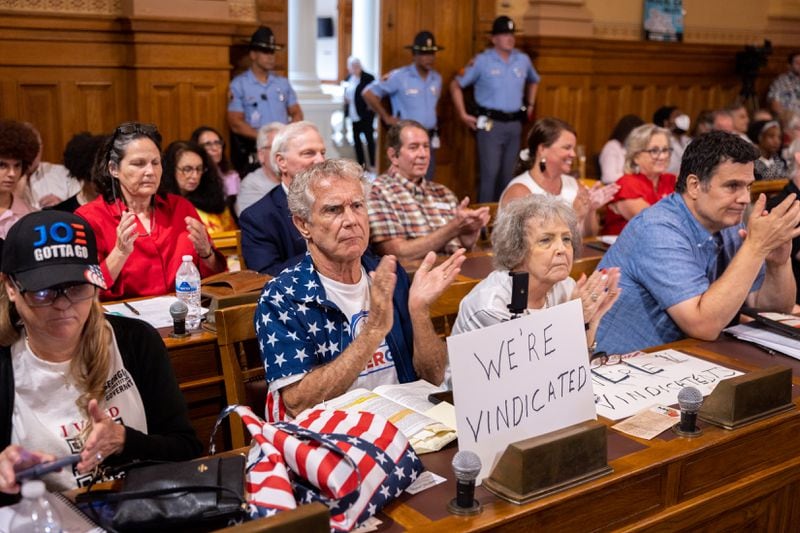 Election skeptics clap during public comment at a State Election Board meeting July 9. (Arvin Temkar / AJC)