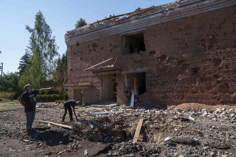 Serhii Zaichenko, 63, school guard shows his school which was heavily damaged after Russian airstrike in Mohrytsia, near Russian-Ukrainian border, Sumy region, Ukraine, Wednesday, Aug. 14, 2024. Zaichenko said two people were killed, including one child. (AP Photo/Evgeniy Maloletka)