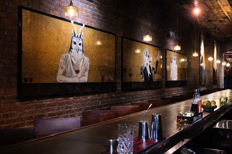 Paintings of animals drinking beer hang near the bar at Porter Beer Bar in Atlanta's Little Five Points neighborhood.  / Courtesy of Porter Beer Bar