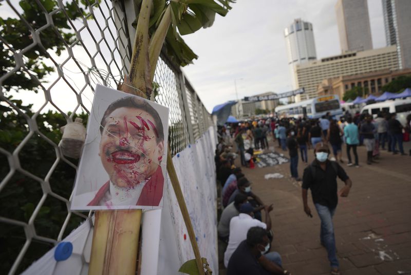 A vandalized portrait of Prime Minister Mahinda Rajapaksa is seen at a protest site outside President Gotabaya Rajapaksa's office in Colombo, Sri Lanka, Saturday, April 23, 2022. (AP Photo/Eranga Jayawardena, File)