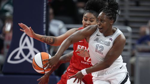 Las Vegas Aces' Chelsea Gray (12) makes a pass against Indiana Fever's Damiris Dantas during the first half of a WNBA basketball game, Wednesday, Sept. 11, 2024, in Indianapolis. (AP Photo/Darron Cummings)