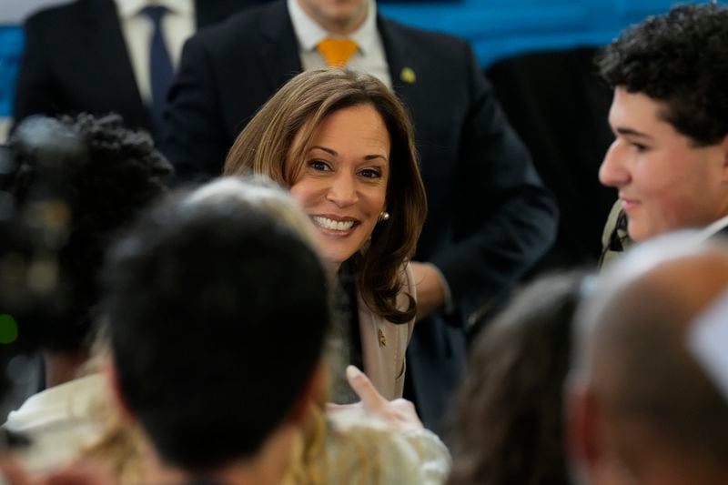 Democratic presidential nominee, Vice President Kamala Harris, center, greeting student volunteers at an unscheduled stop at Community College of Philadelphia, Tuesday, Sept. 17, 2024, in Philadelphia. (AP Photo/Jacquelyn Martin)