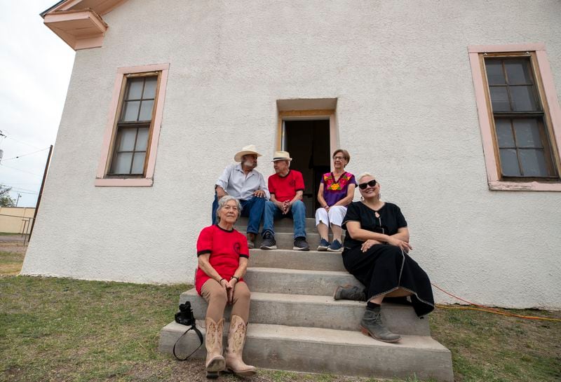 From left, alumni Betty Nuñez Aguirre, musician Remigio "Primo" Carrasco, alumni Ismael Vasquez, his wife Elisa Vasquez and Gretel Enck, former president of the Blackwell School Alliance, sit at the school entrance during its inauguration as the newest National Historic Site in Marfa, Texas, Saturday, Sept. 14, 2024. (AP Photo/Andres Leighton)